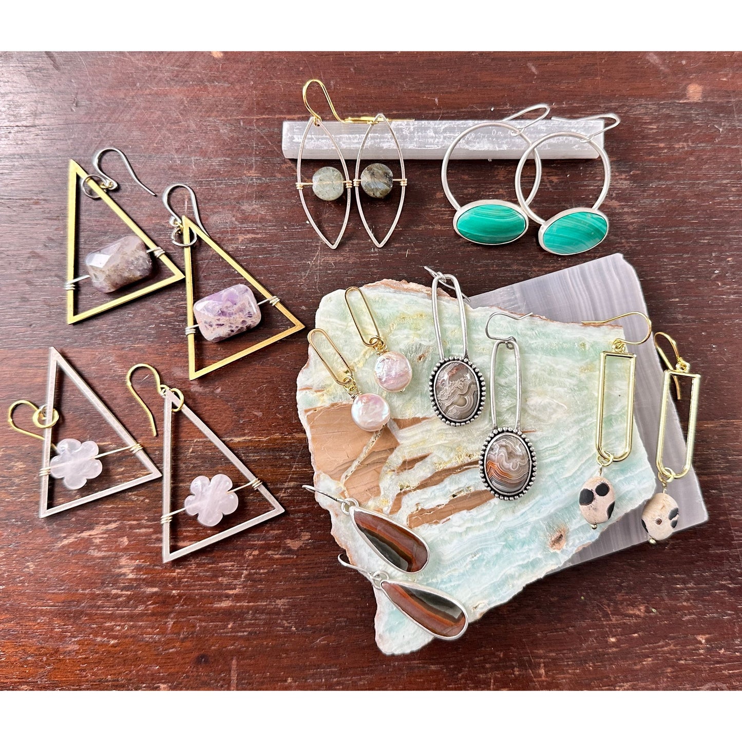 Collection of various earrings on a wooden surface