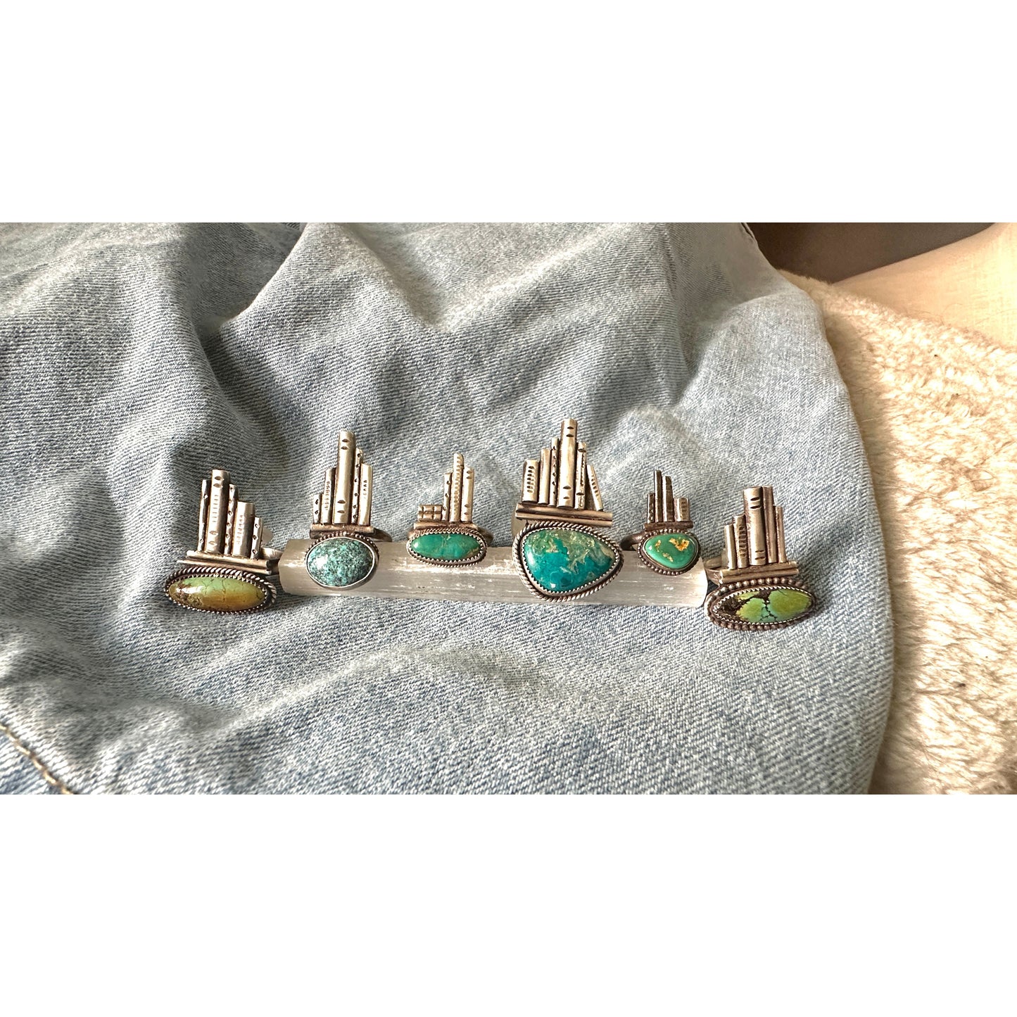 Silver rings with turquoise stones on a denim background