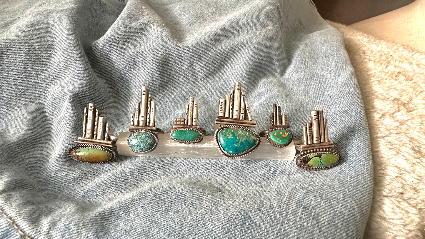 Silver rings with turquoise stones on a denim background