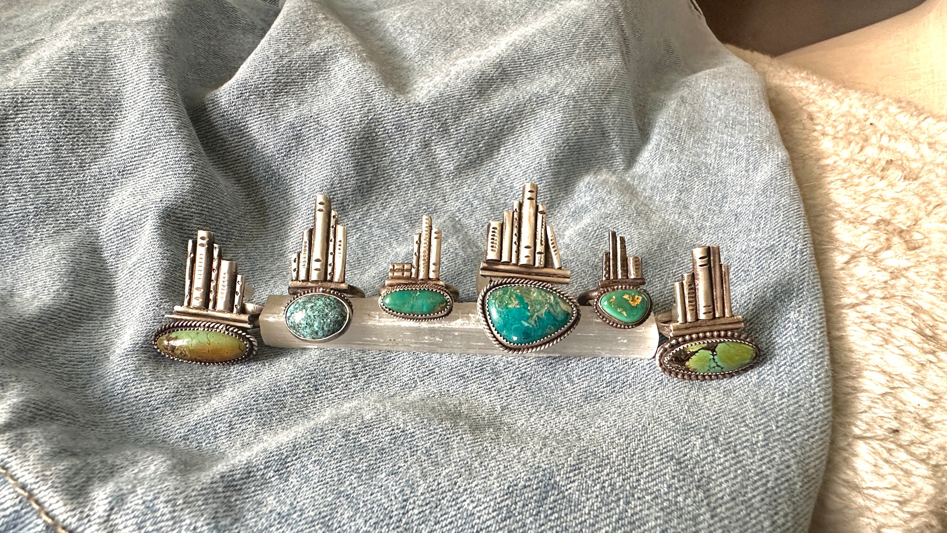 Silver rings with turquoise stones on a denim background