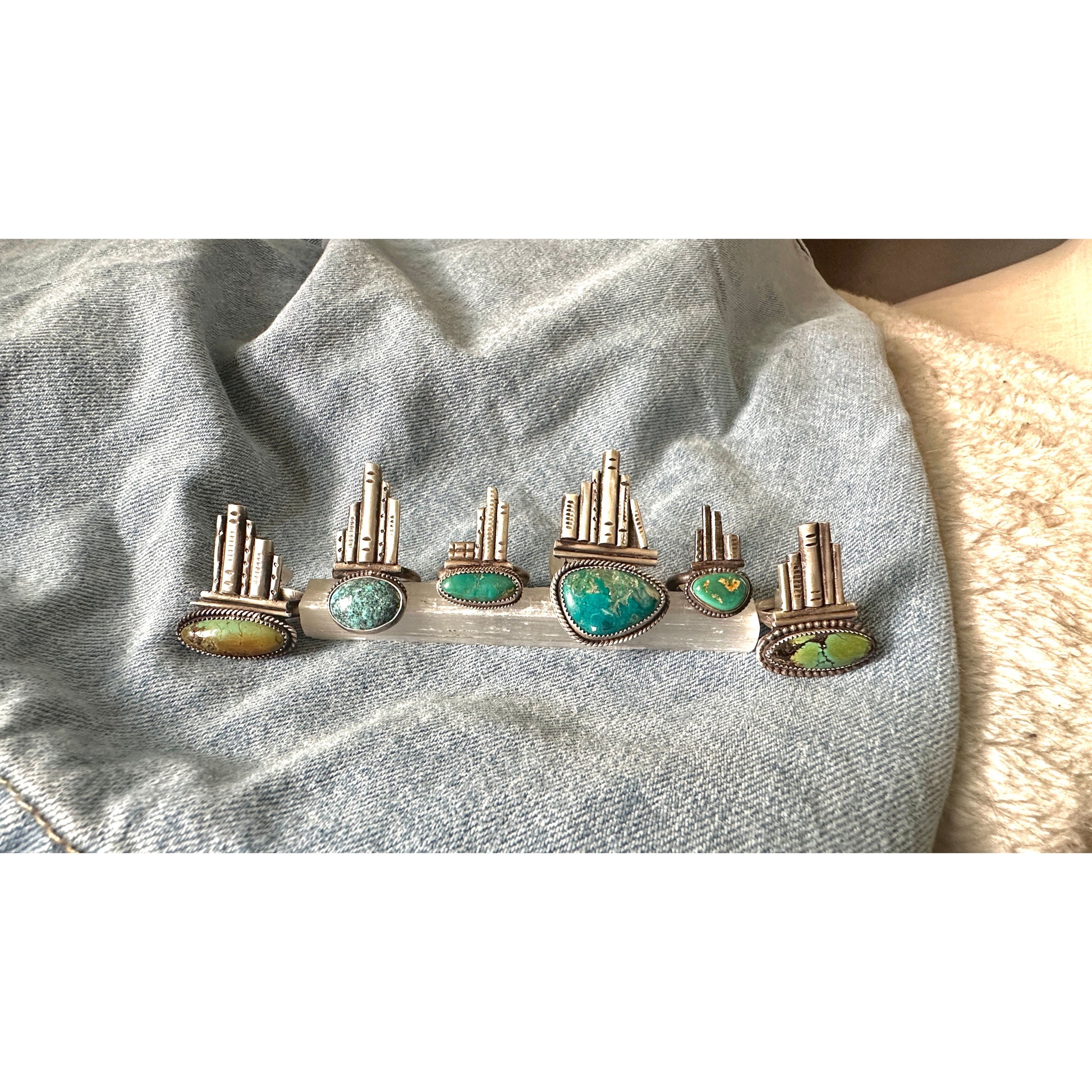 Silver rings with turquoise stones on a denim background
