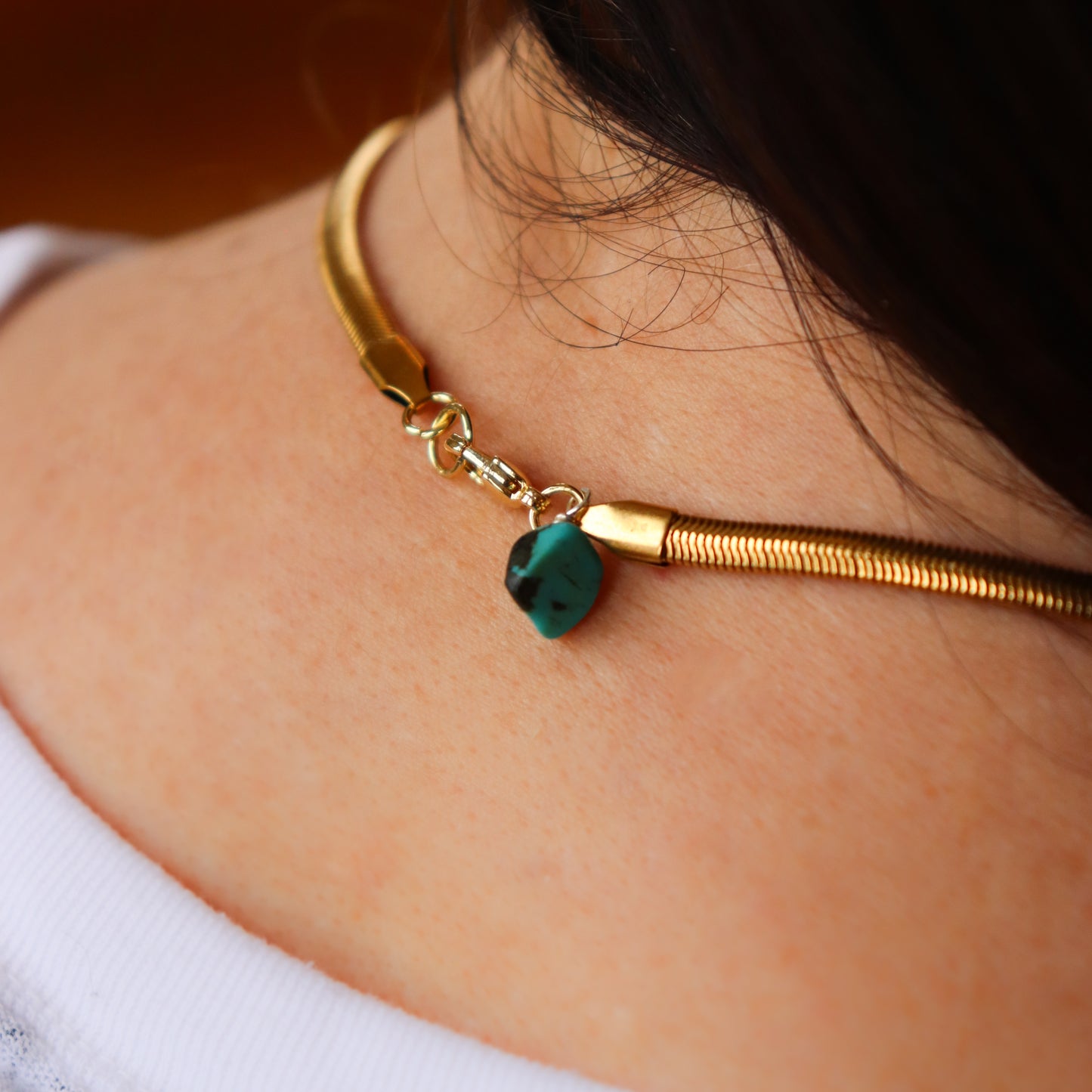 clasp of necklace on person
