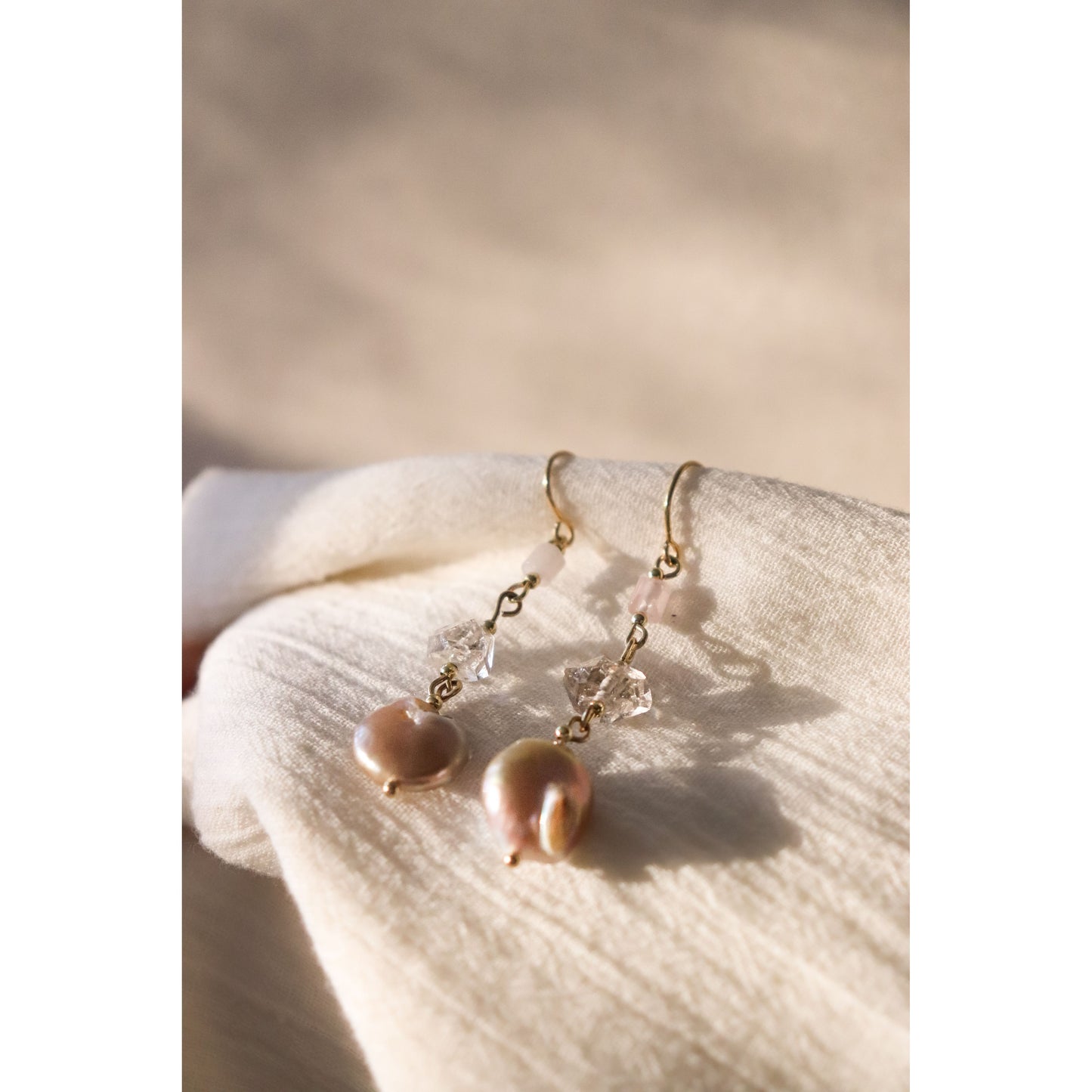 gemstone Earrings laying with sun shining on them