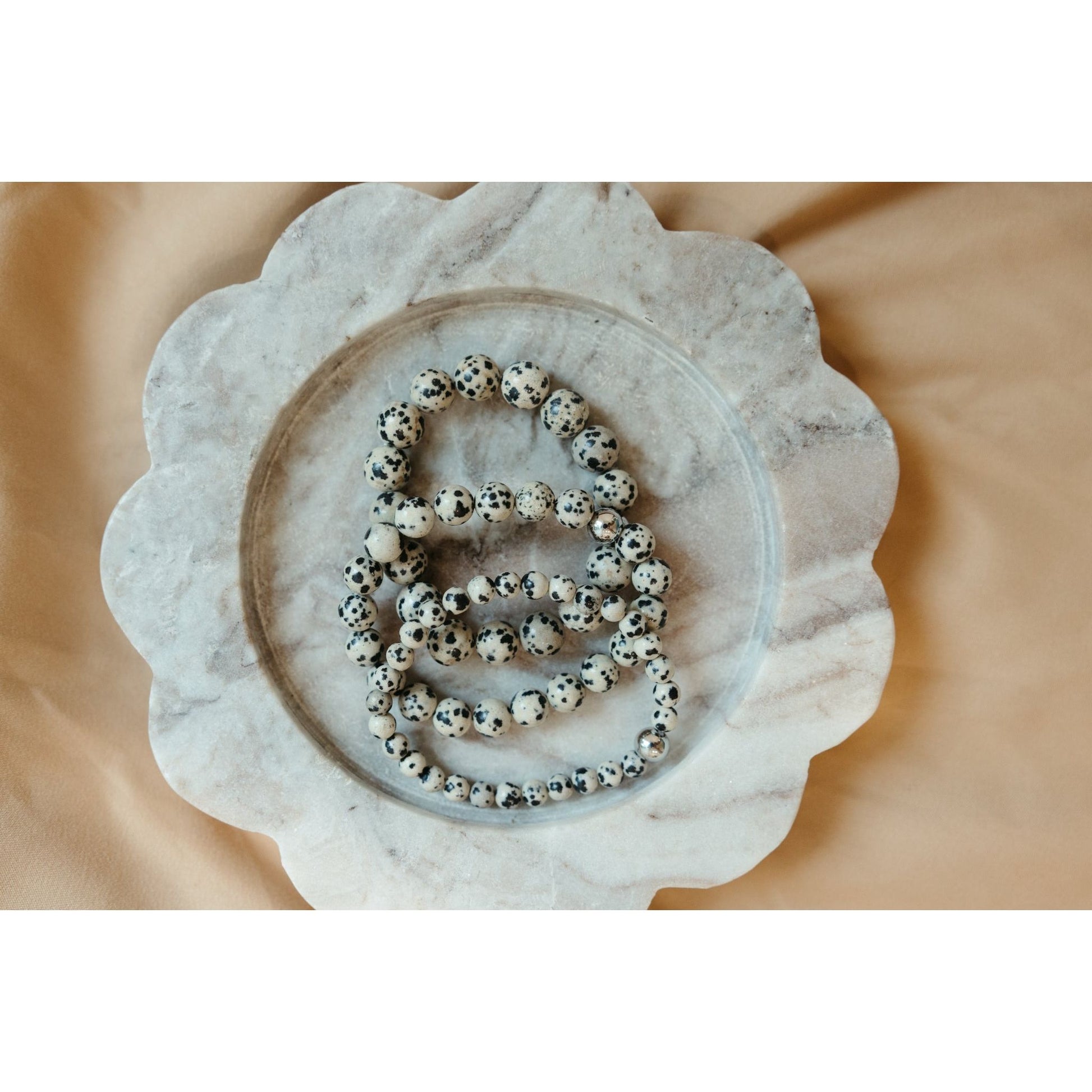 Bracelets with black and white beads on a decorative stone plate