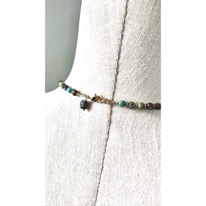Necklace with turquoise beads on a white fabric background