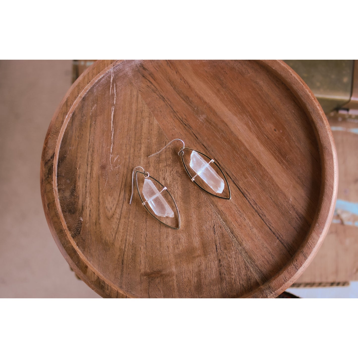 Pair of earrings on a wooden surface