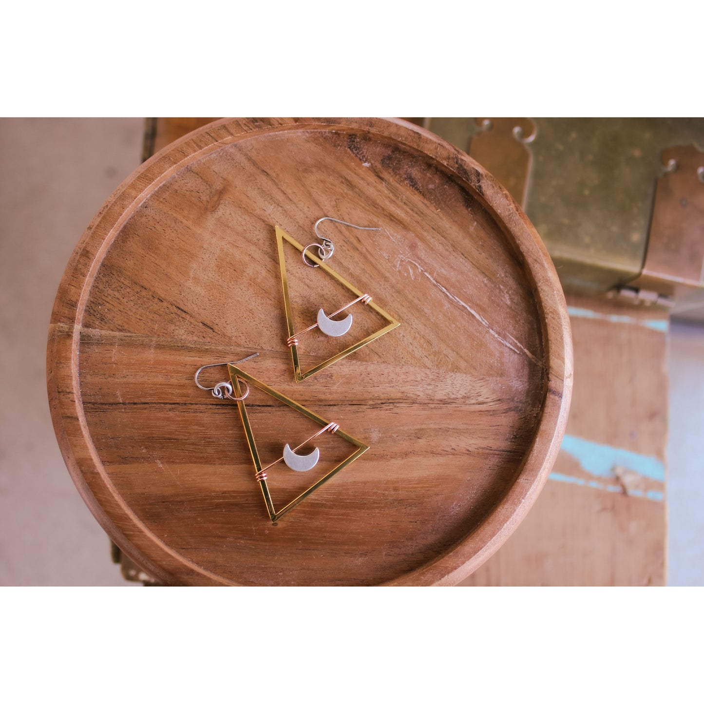 Geometric earrings on a wooden surface