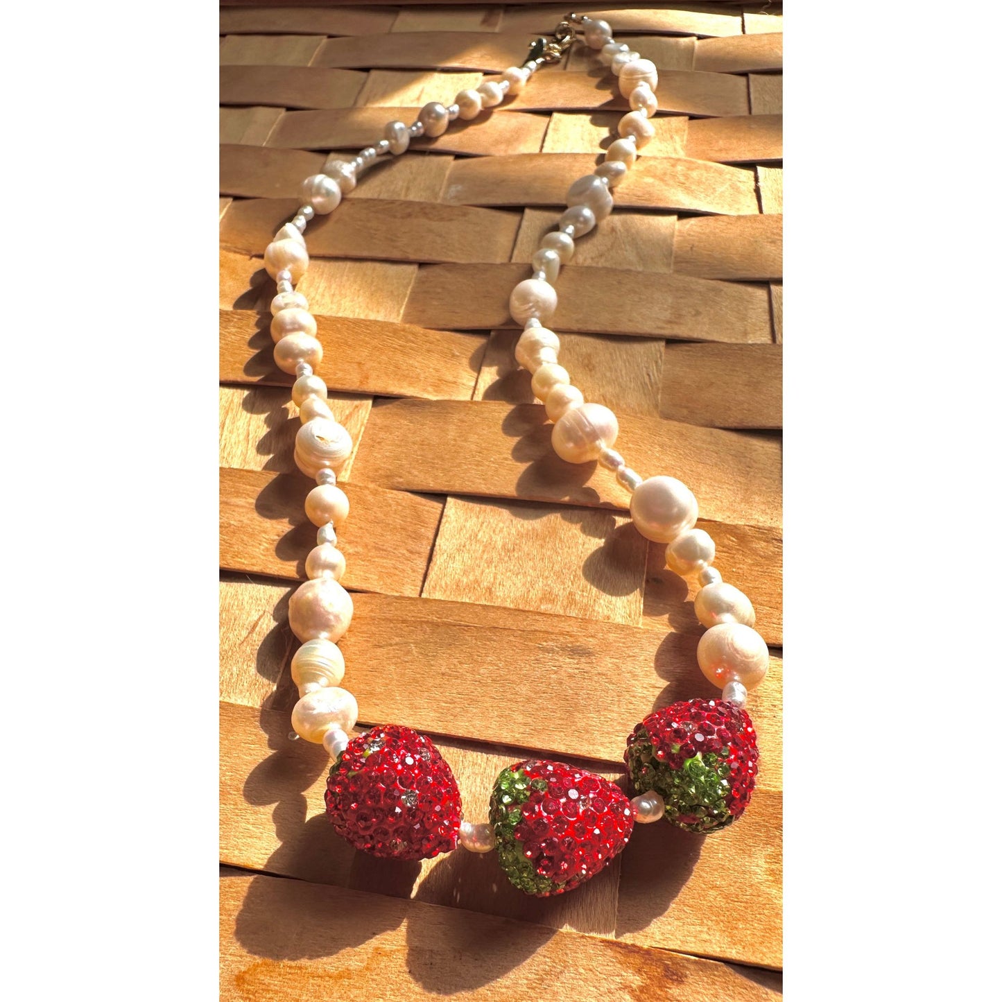 close up of pearl and strawberry necklace