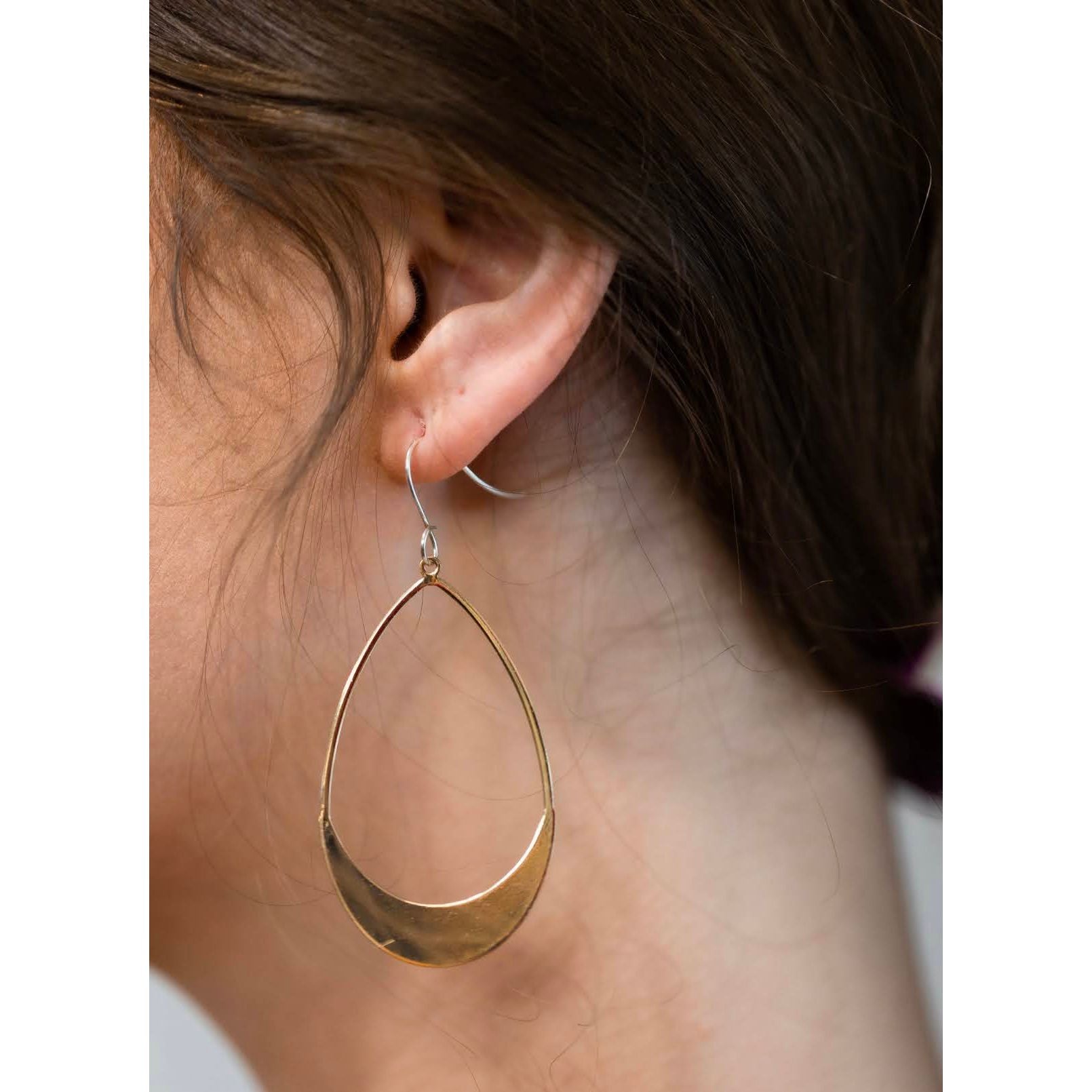 Gold Earring on model from side view
