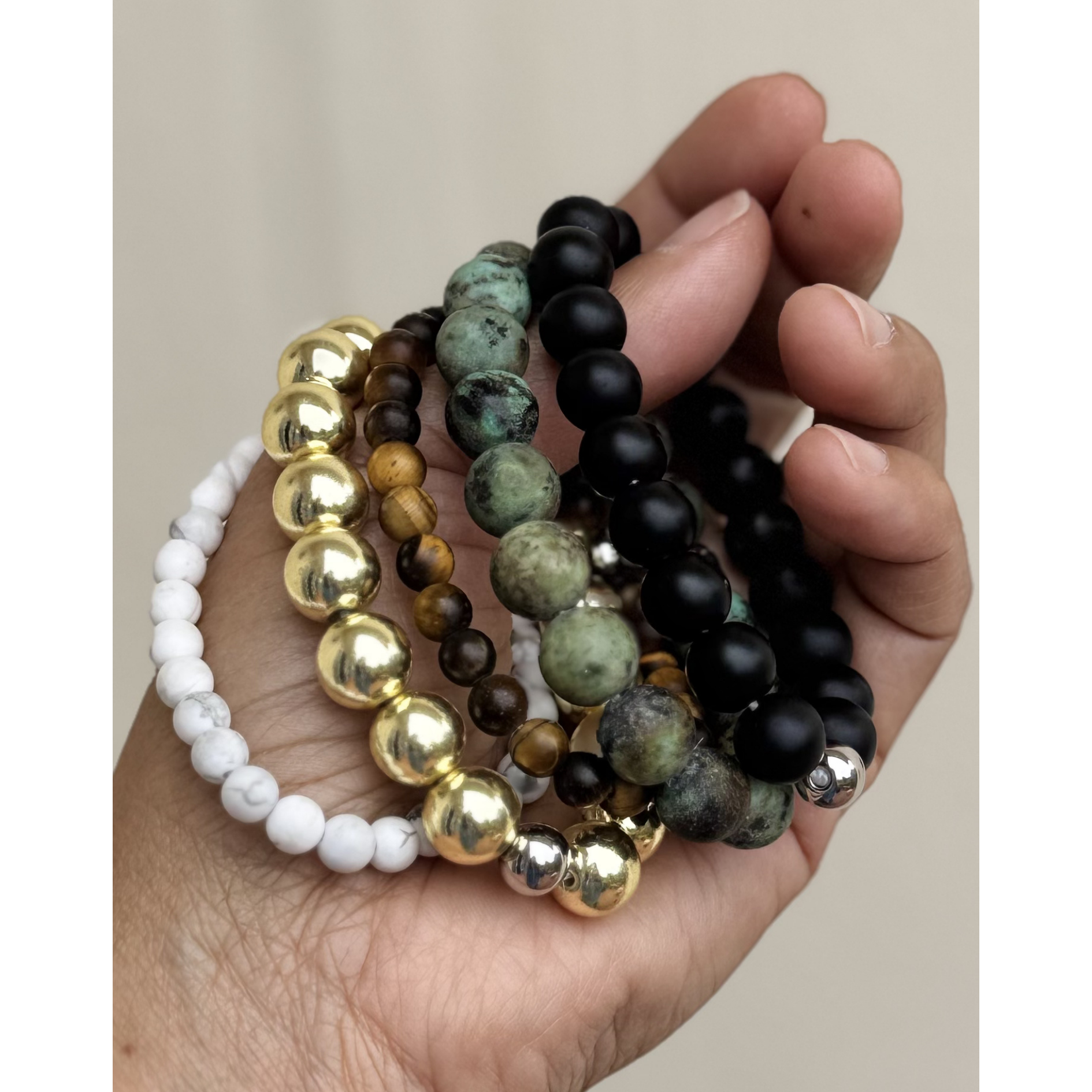 Hand full of mixed gemstone bracelets