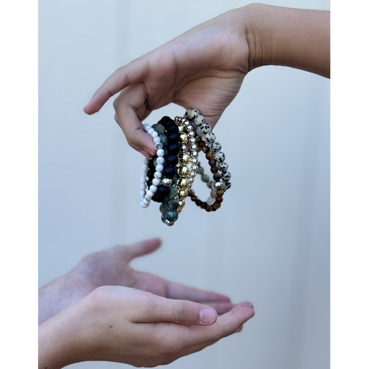 two hands Handing off stack of bracelets