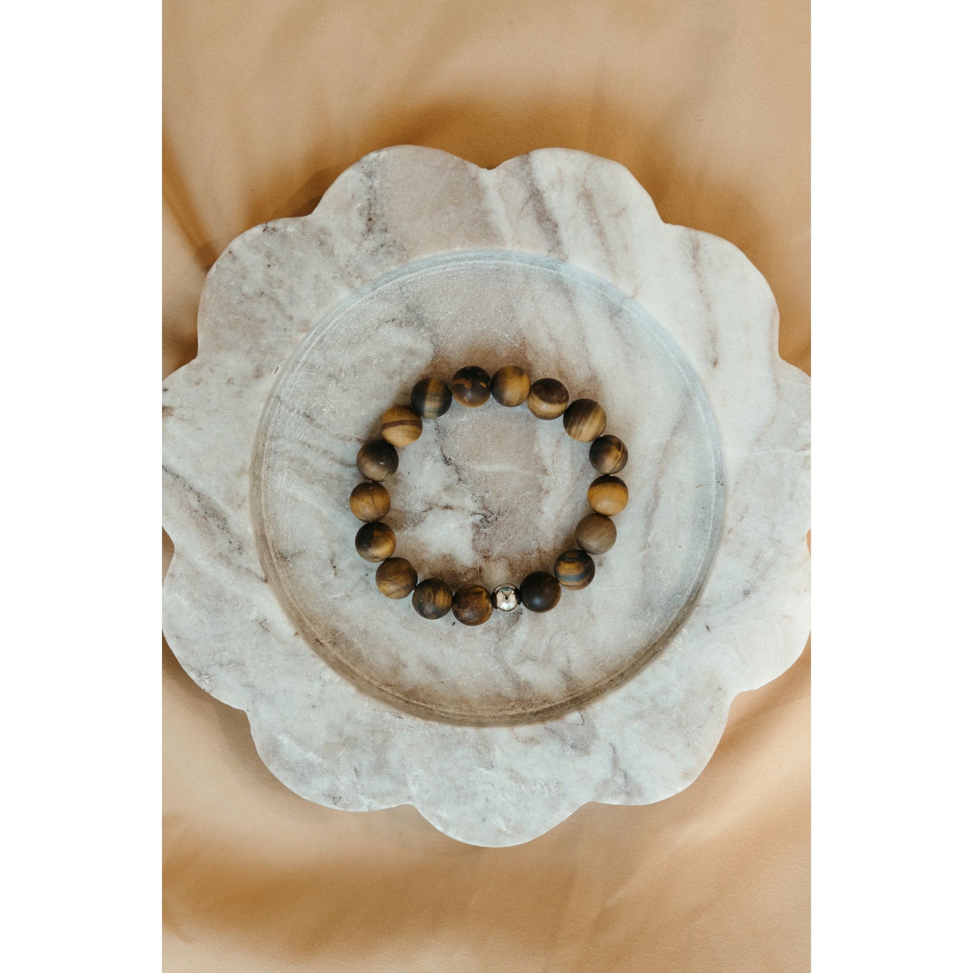 Tigers eye bracelet on white marble platter