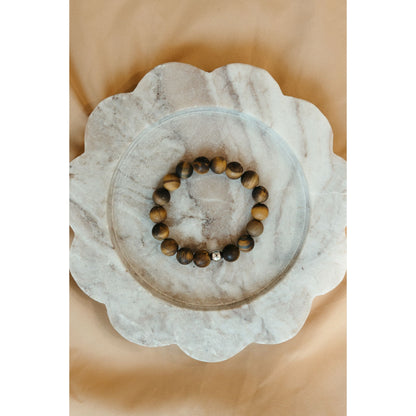 Tigers eye bracelet on white marble platter