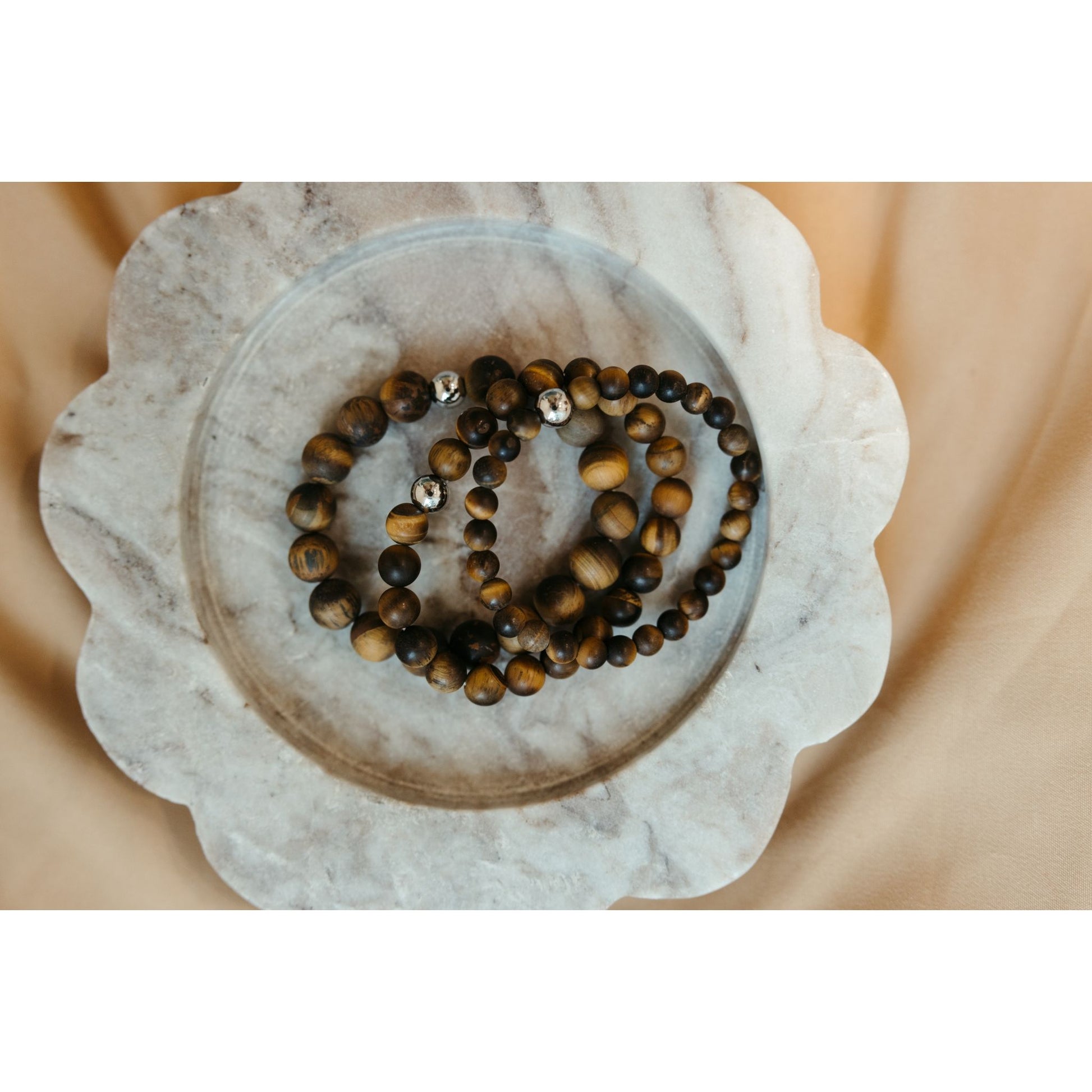 3 bracelets on marble surface