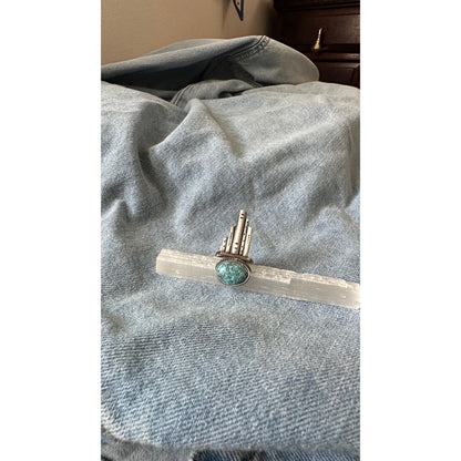 Silver and turquoise ring on denim fabric