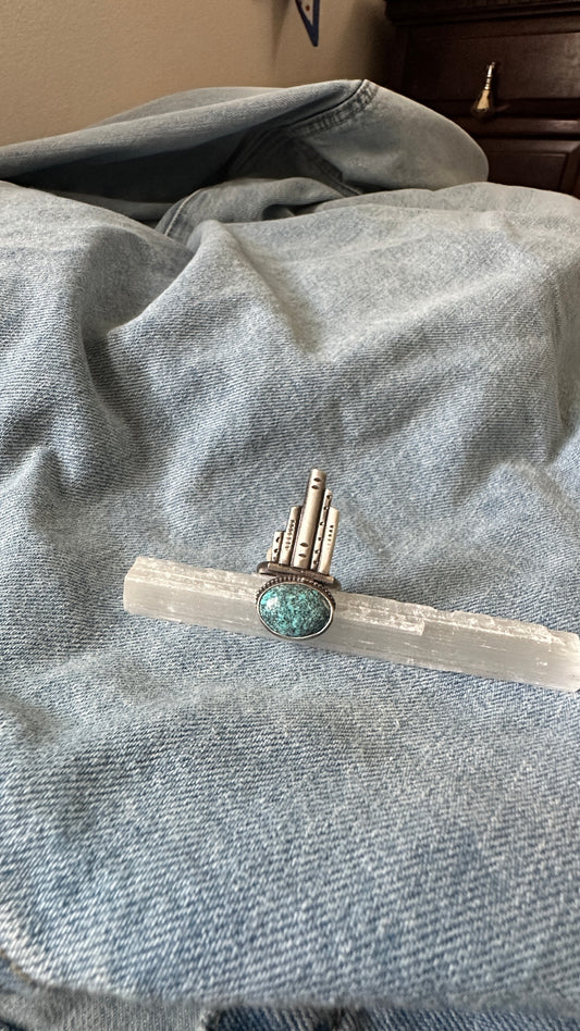 Silver and turquoise ring on denim fabric