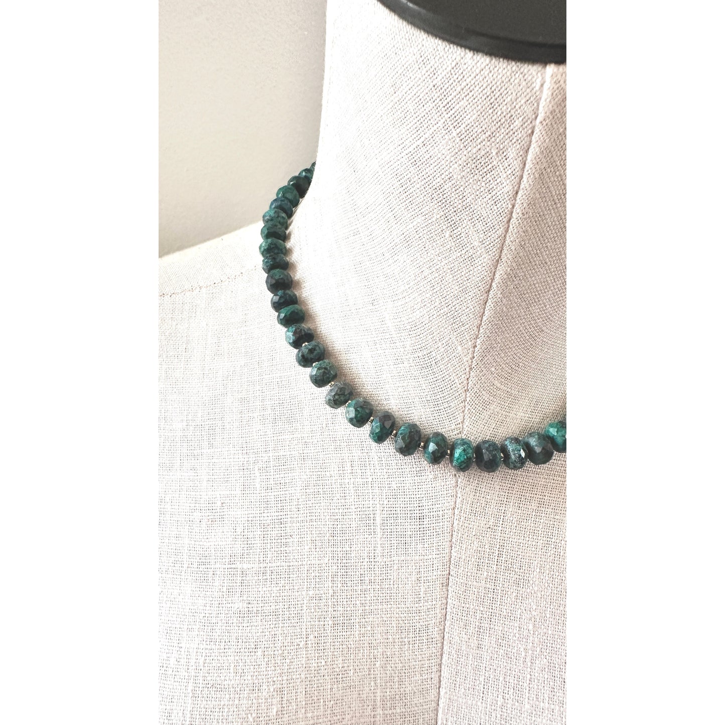Necklace with blue beads on a mannequin