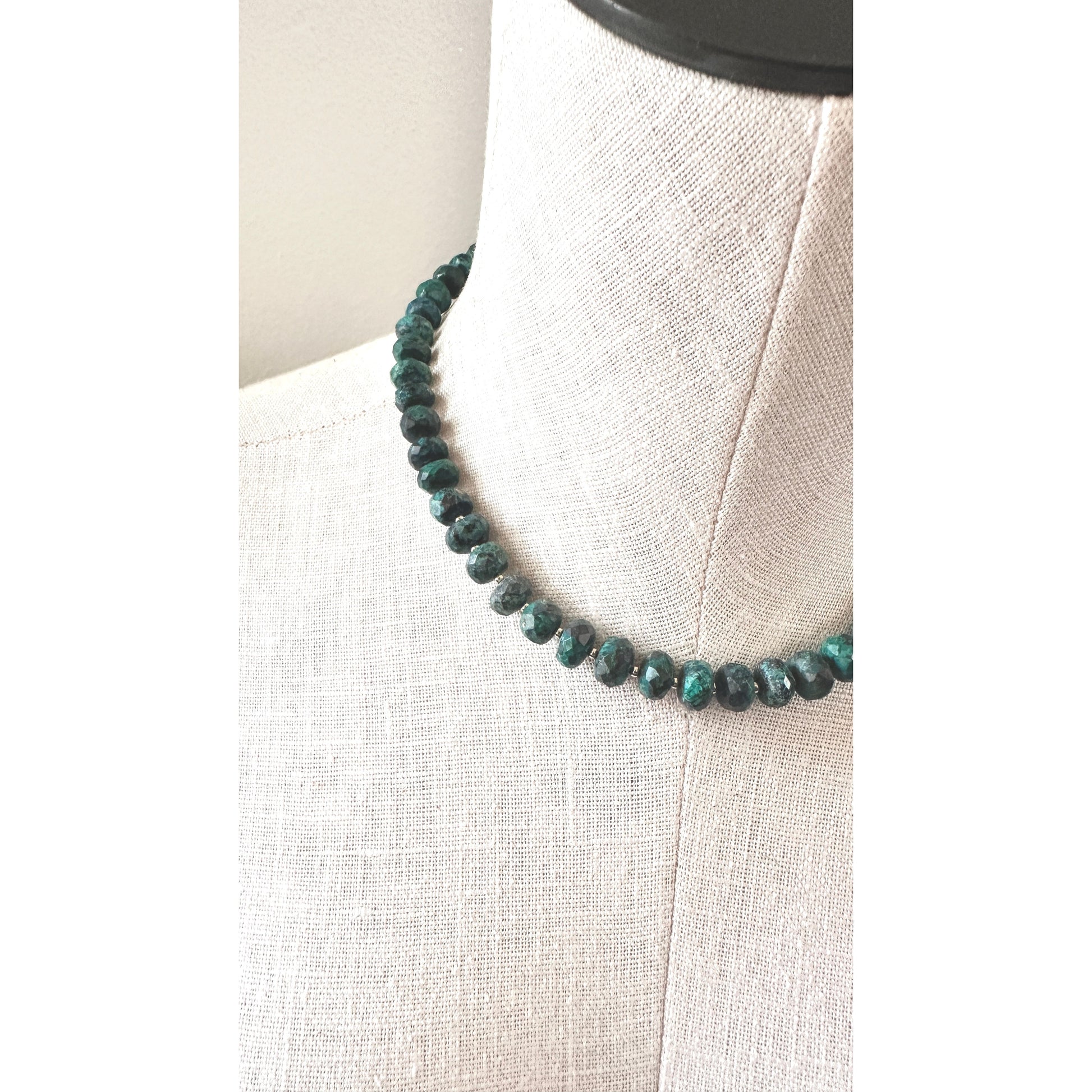 Necklace with blue beads on a mannequin